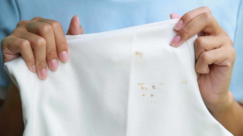Woman blotting stain white cloth