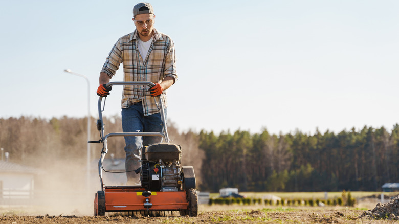 A person pushign an aerator