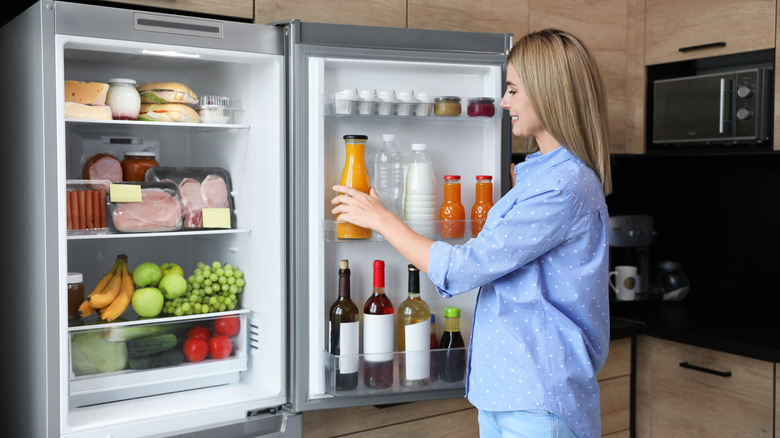 woman opening refrigerator