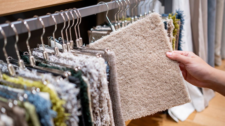 person looking at carpet samples