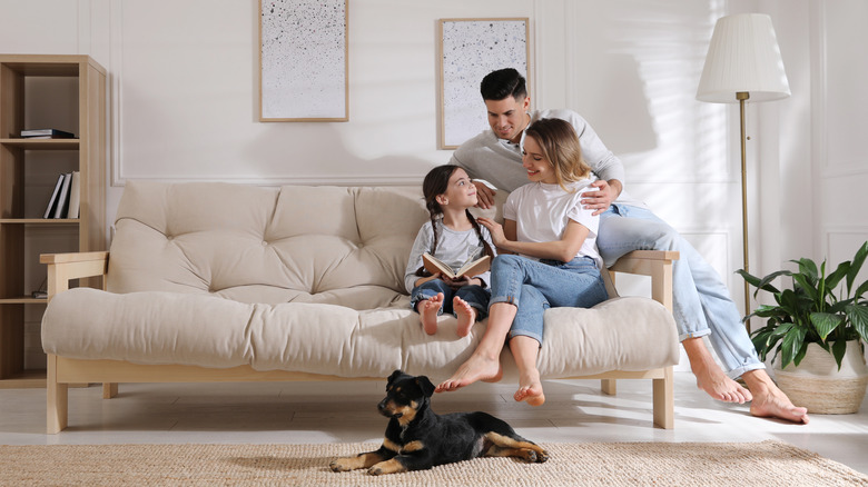 family reading book on couch