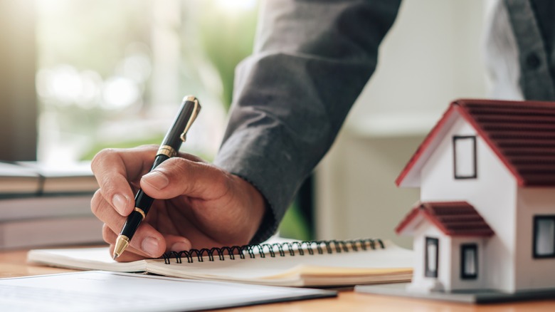 man signing insurance papers