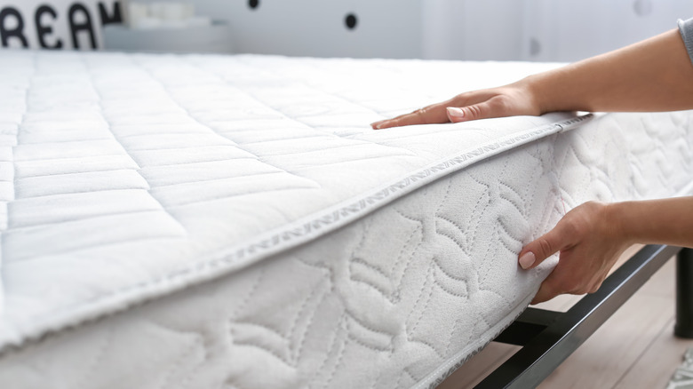 hands touching white mattress