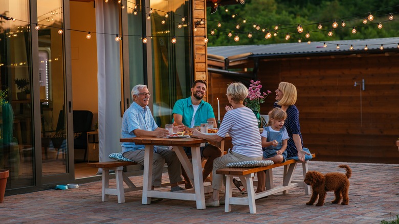 family dining on outside patio