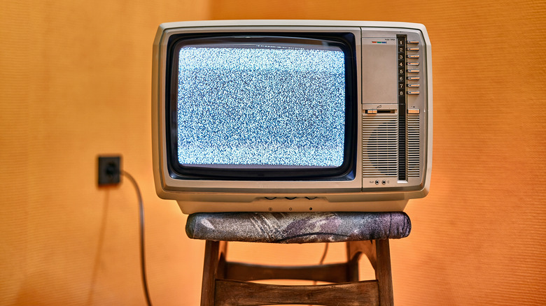 old TV plugged in on stool
