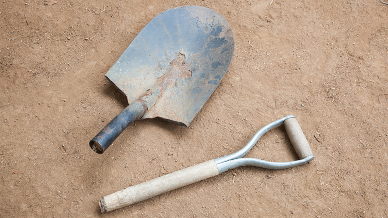 A broken shovel on the ground