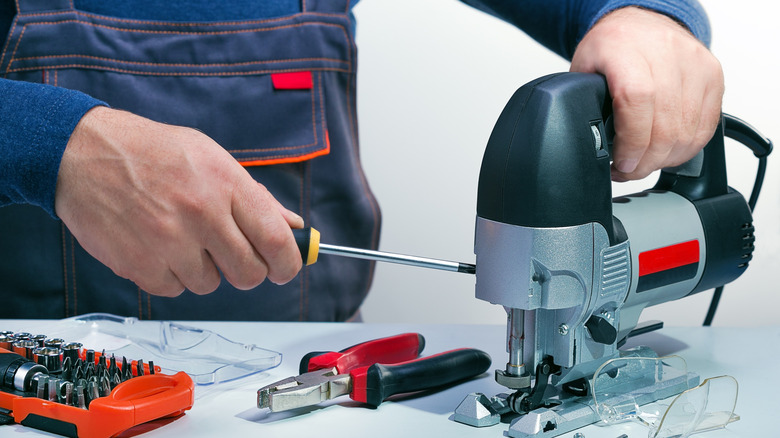 A technician servicing a power tool