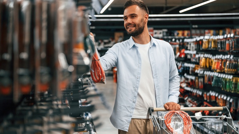 Man shopping for cables at a hardware store