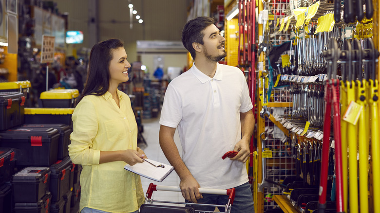 Woman and man shopping for tools at a hardware store