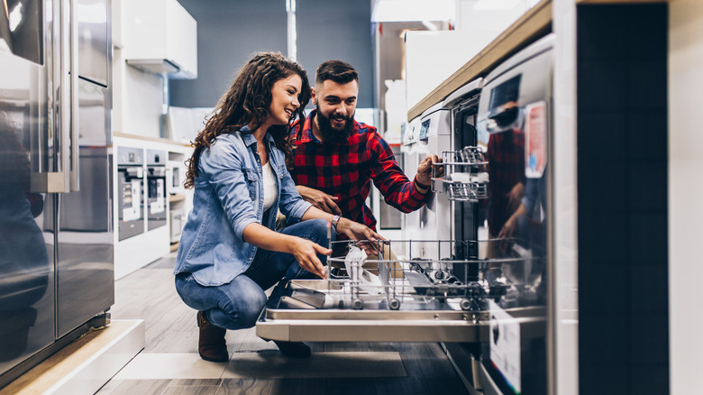 couple looking at dishwasher