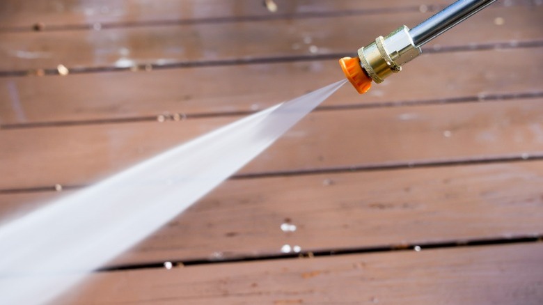 Power washing a wooden deck