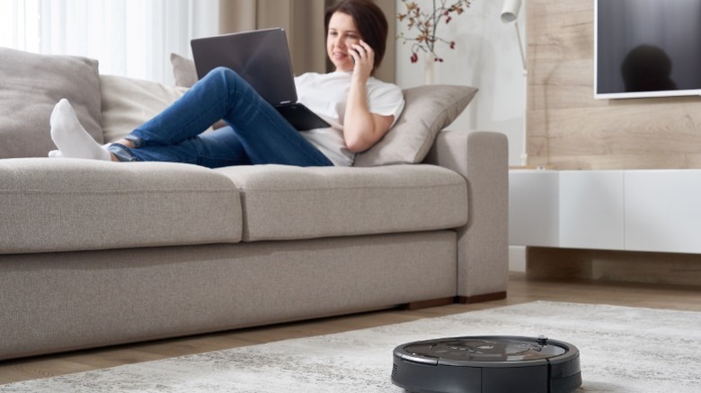 Woman running robot vacuum