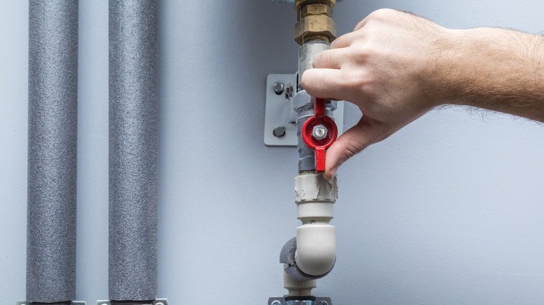 A person turning off the water supply