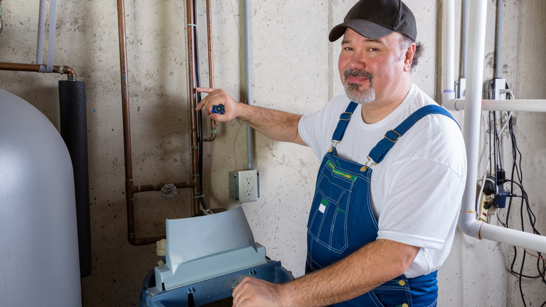 A man installing a water softener