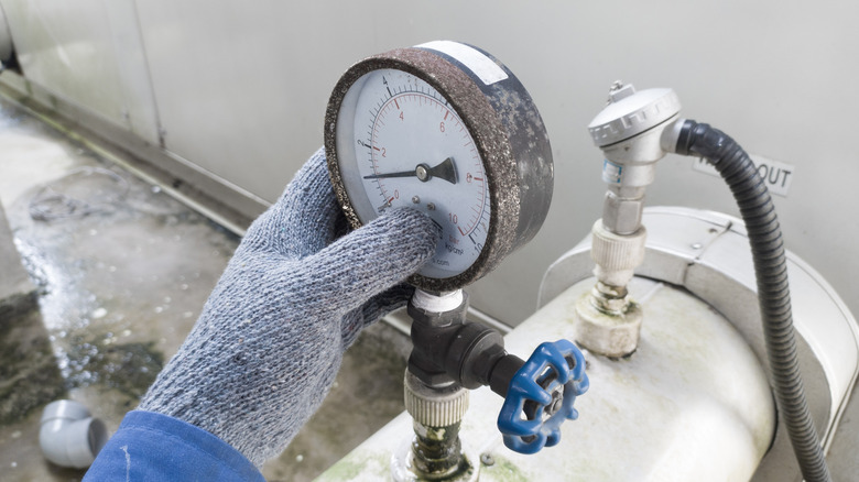 A person checking water pressure