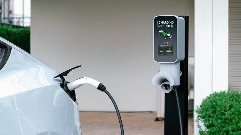 White vehicle charging on a home EV charging station