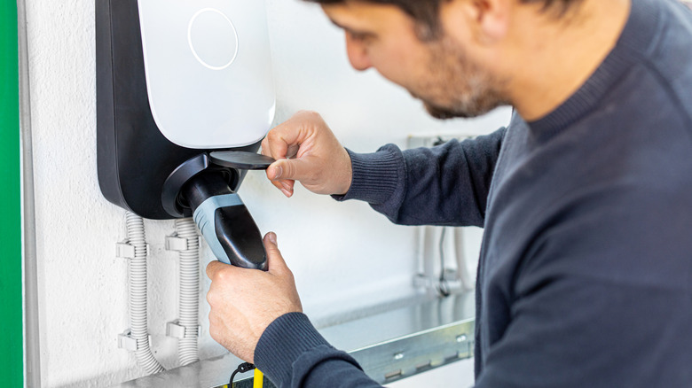Person using an EV charging station in their home