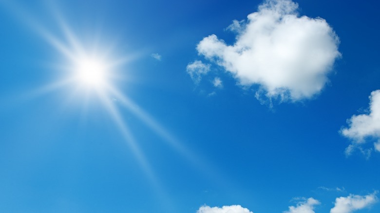 Sun high in sky, clouds