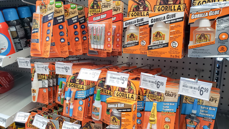 Several formulations of Gorilla Glue hanging at the store
