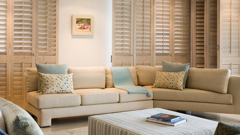 Living room with muted blue and beige furnishings