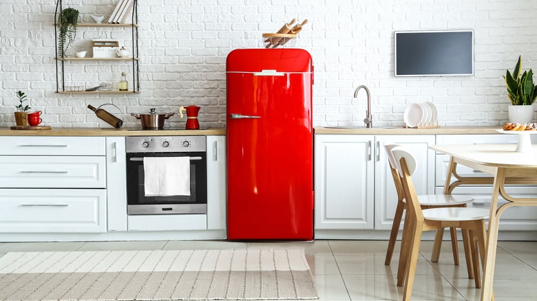 Red fridge in white kitchen