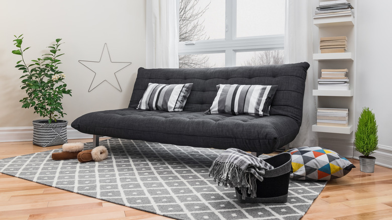 a gray futon in an open living room
