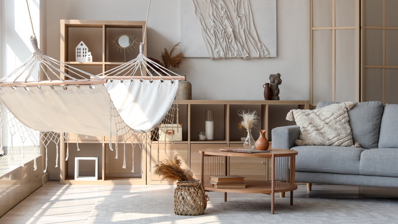a white hammock in a boho rustic style living room