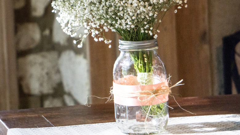 Mason jar with pink ribbon and baby's breath
