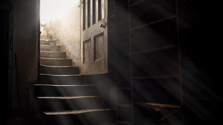 Light streaming through doorway into dark basement