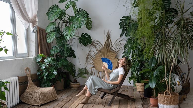 Woman relaxing in plant room