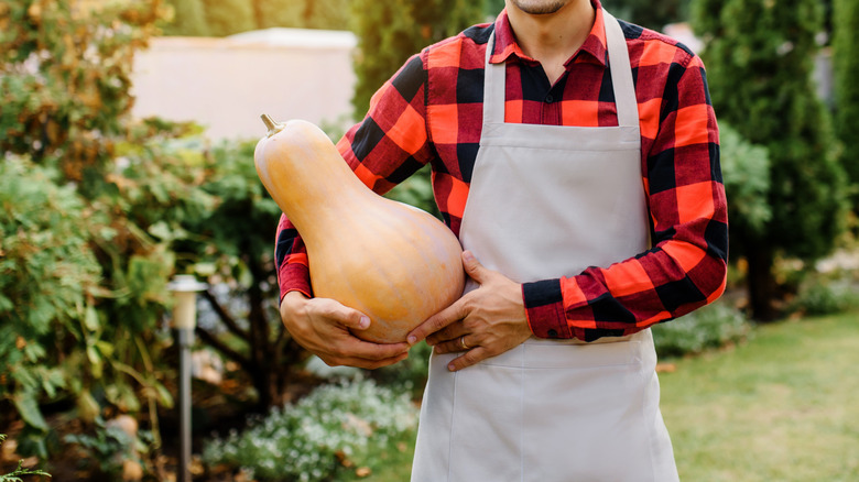 A man holding a dried gourd