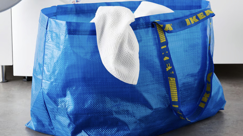 IKEA FRAKTA bag holding linens, used as a laundry hamper