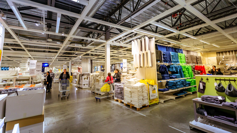 Shoppers in IKEA shopping in varying aisles.