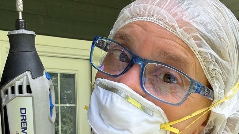 Woman wears shower cap as she prepares for project that produces dust.