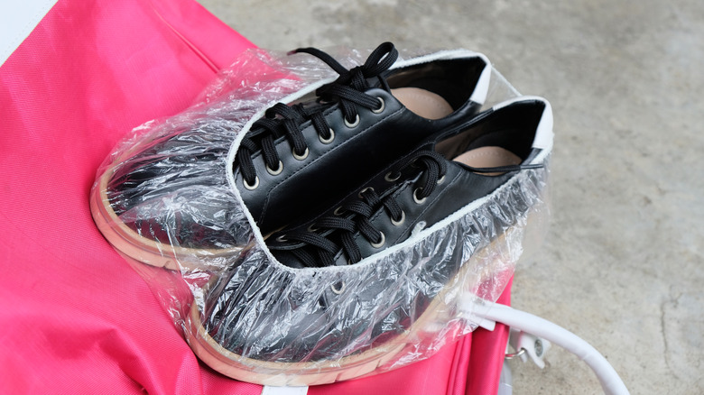 Shoes are wrapped in a shower caps so they don't spread dirt onto other travel items.