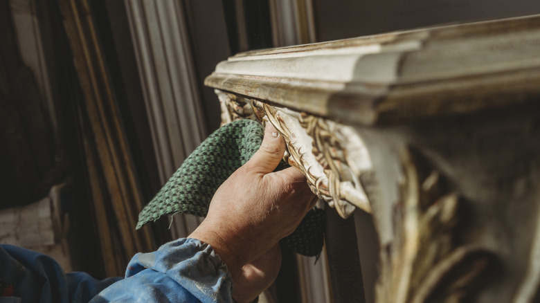person restoring wood furniture