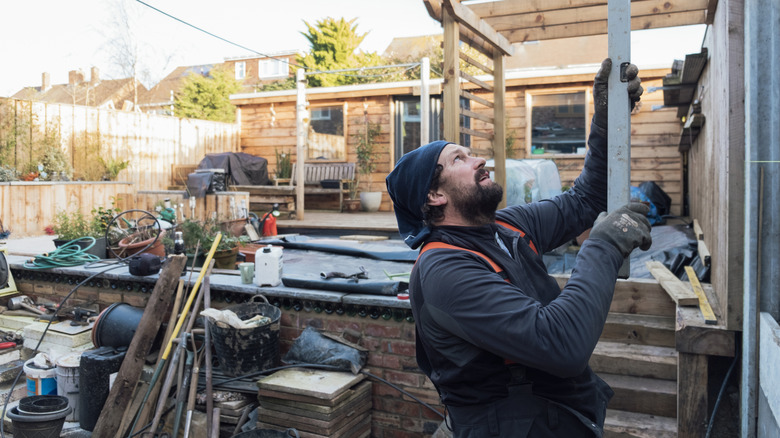 Man building a wall in backyard