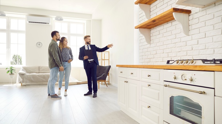 Couple touring home with realtor