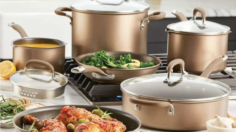 Circulon Premier Professional Cookware Set on a stove and counter with food and ingredients
