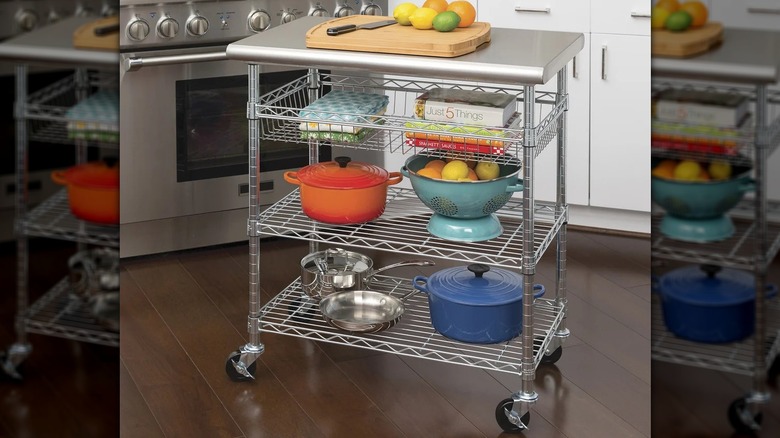 The Seville Classics Kitchen Cart holding a cutting board and other supplies in a kitchen