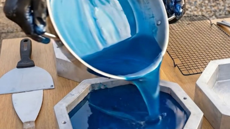 Person pouring melted plastic into a mold