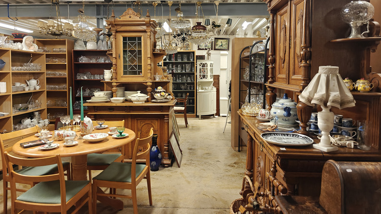 A large thrift store with a wide range of furniture, dishes and other collectibles being sold