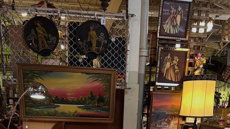 Art pieces and lamps on display at a thrift store