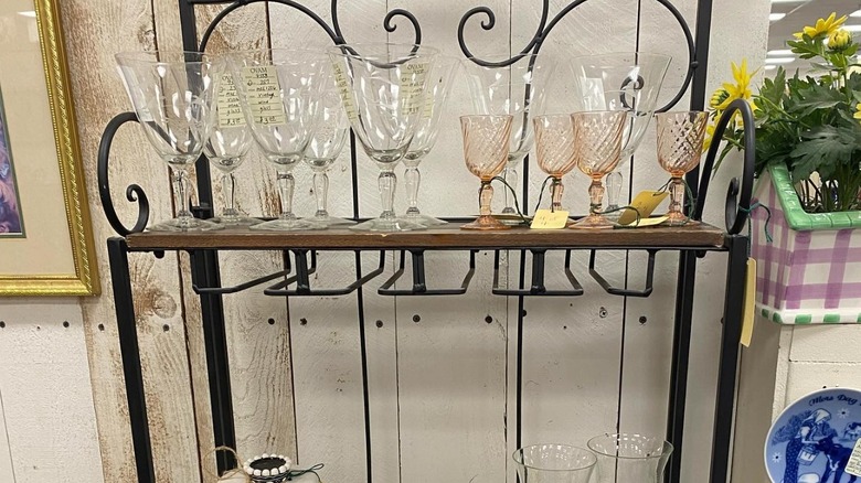 Vintage glasses displayed on a rustic shelf