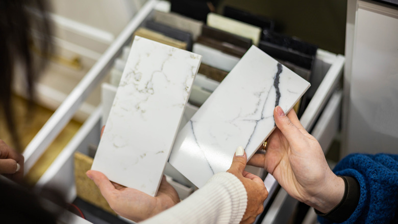 Two people viewing countertop material samples together
