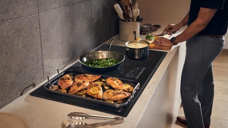 A man using an LG induction cooktop