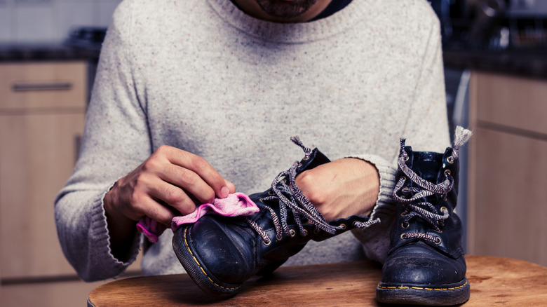 Man cleaning leather boots