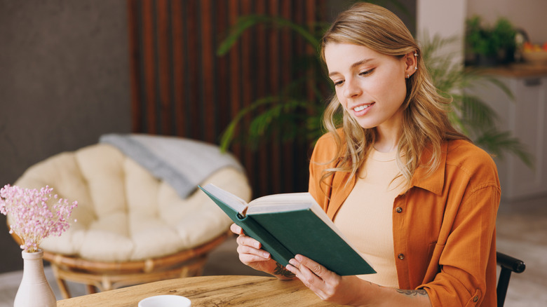Woman reading a coffee table book