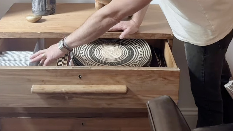 Napkins and placemats inside wooden chest of drawers
