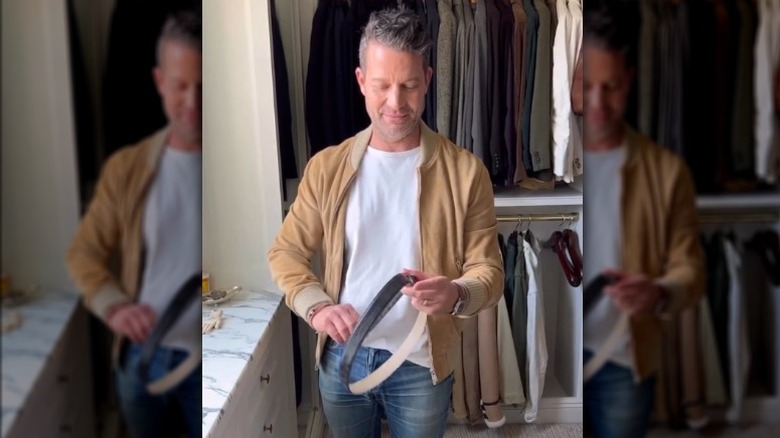Nate Berkus folding a belt
